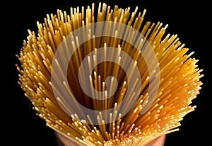 Assortment of dry pasta spaghetti, orzo, noodles and creste di gallo over black textured background. Top view