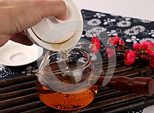 Assortment of dry tea in spoons, on wooden background