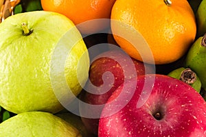 Assortment of exotic fruits  guava and orange and red apple on  background fruit health food