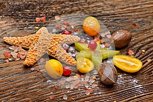 Assortment of exotic fruits, nuts and starfish