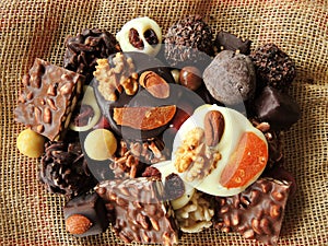 Assortment of fine chocolates in white, dark and milk chocolate closeup