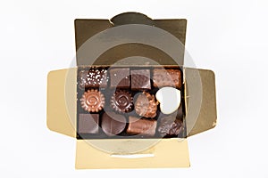 Assortment of fine milk black dark artisanal chocolate candies in small gift golden box