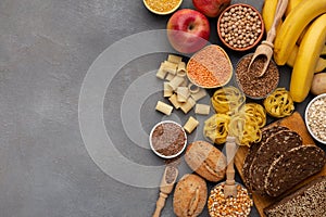 Assortment of food rich on fiber and carbohydrates on gray