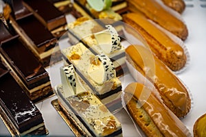 Assortment of french fresh baked sweet pastry with fresh fruits and berries in confectionery shop