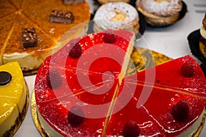 Assortment of french fresh baked sweet pastry with fresh fruits and berries in confectionery shop