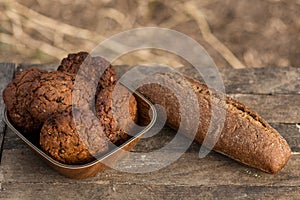 Assortment of fresh baked goods wooden background. baguette and cookies in the open space