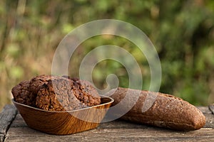 Assortment of fresh baked goods wooden background. baguette and cookies in the open space