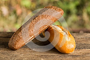 Assortment of fresh baked goods wooden background. baguette and cookies in the open space