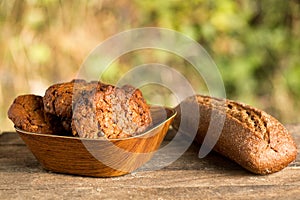 Assortment of fresh baked goods wooden background. baguette and cookies in the open space