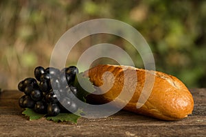 Assortment of fresh baked goods wooden background. baguette and cookies in the open space