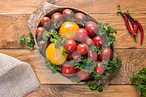 Assortment of fresh colorful tomatoes in oval bowl