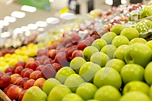 Assortment of fresh fruits at market  blurred background and lights