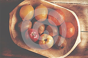 Assortment fresh healthy fruits in handmade wooden bowl made in