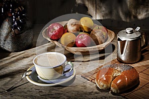 Assortment fresh healthy fruits in handmade wooden bowl made in Ecuador on wooden background. Coffee percolator, cup of coffee, b