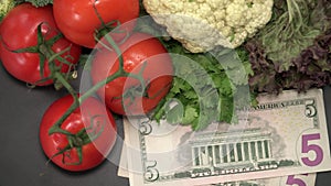 Assortment of Fresh Raw Vegetables with American National Currency US Dollars Including Tomatoes, Cucumber, Cauliflower