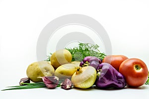 Assortment of fresh raw vegetables on white background. Selection includes potato, tomato, green onion, pepper, garlic and dill