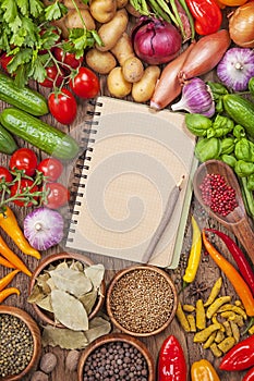 Fresh vegetables and blank recipe book photo