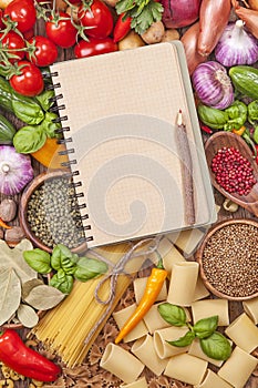 Assortment of fresh vegetables and blank recipe book