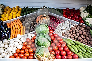 Assortment of fresh vegetables at market counter, vegetable shop, farmer marketplace. Organic, healthy, vegetarian diet food conce