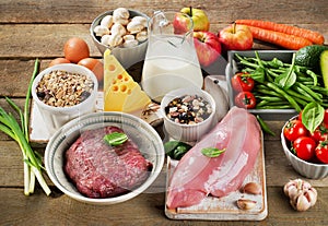 Assortment of Fresh Vegetables and Meats for Healthy Diet on rustic table. photo