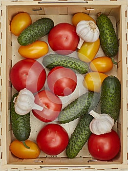 Assortment of fresh vegetables in a wooden box