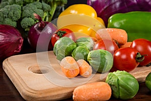 Assortment of fresh vegetales on cutting board photo