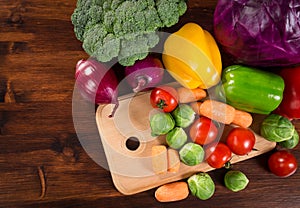 Assortment of fresh vegetales on wooden table with copyspace photo