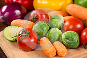 Assortment of fresh vegetales on wooden table photo