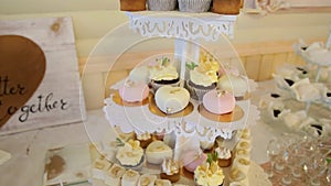 An assortment of fruits, drinks, sweet cakes and cupcakes offered to guests at the wedding reception.