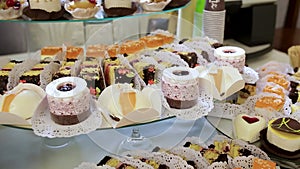 An assortment of fruits, drinks, sweet cakes and cupcakes offered to guests at the wedding reception.