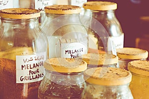 Assortment of glass jars on shelves in herbalist shop on a traditional Moroccan market (souk) in Essaouira, Morocco