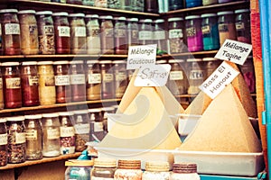 Assortment of glass jars on shelves in herbalist shop on a traditional Moroccan market (souk) in Essaouira, Morocco