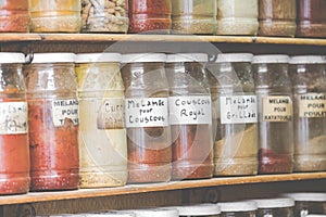 Assortment of glass jars on shelves in herbalist shop on a traditional Moroccan market (souk) in Essaouira, Morocco