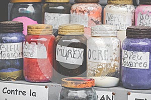 Assortment of glass jars on shelves in herbalist shop on a traditional Moroccan market (souk) in Essaouira, Morocco