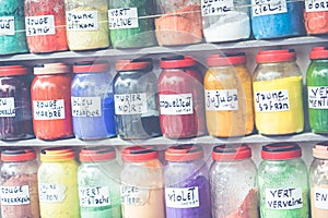 Assortment of glass jars on shelves in herbalist shop on a traditional Moroccan market (souk) in Essaouira, Morocco