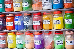 Assortment of glass jars on shelves in herbalist shop on a traditional Moroccan market (souk) in Essaouira, Morocco