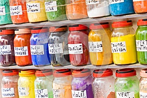 Assortment of glass jars on shelves in herbalist shop on a traditional Moroccan market (souk) in Marrakech, Morocco