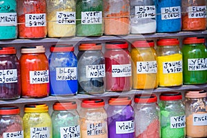 Assortment of glass jars on shelves in herbalist shop on a traditional Moroccan market (souk) in Marrakech, Morocco