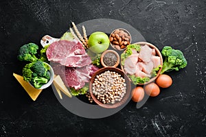 Assortment of healthy protein source and body building foods. Meat, chicken fillet, broccoli, beans, cheese, eggs, wheat.