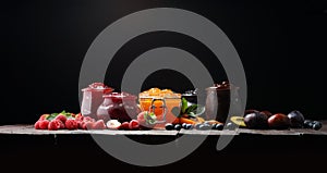 Assortment of jams, seasonal berries, apricot, mint and fruits.