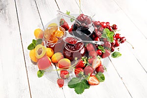 Assortment of jams, seasonal berries, apricot, mint and fruits. marmalade or confiture