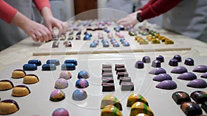 Assortment of luxury handmade chocolate candy collection on white table. Set of colorful chocolate bonbons. Women