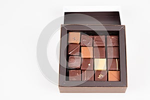 Assortment many small square fine chocolate candies in gift box