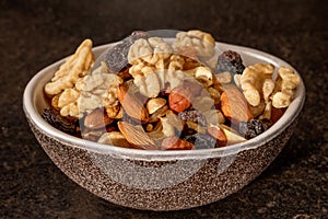 Assortment of mixed nuts and dried fruits for a healthy snack, close-up view