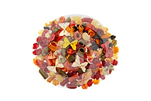 Assortment multicolored pasta different types on white background, top view. Italian pasta with a variety of vegetable flavors.