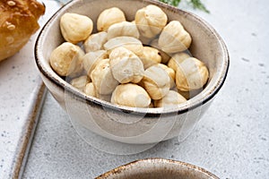 Assortment of nuts in bowl, on white stone table background