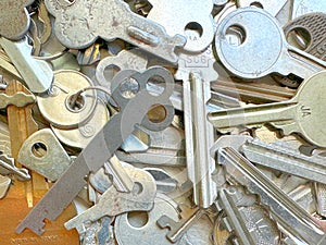 assortment of old metal keys lying in a jumble