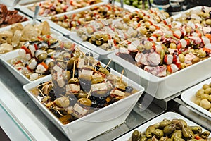 Assortment of olives, pickles and salads on market stand