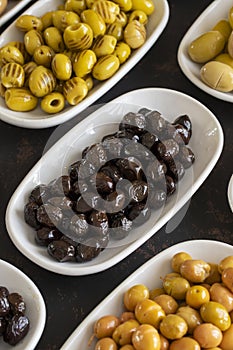 Assortment of olives on the plate in bulk. Selective focus