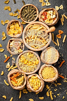 Assortment of pasta on black stone table